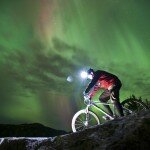 BKE-11126 - Night mountain bike riding with aurora borealis northern lights near Marquette Michigan.