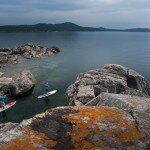 SUP-10688 - Stand up paddlers explore the rugged shoreline of Lake Superior while paddling near Marquette Michigan.